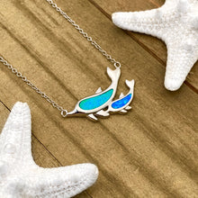 Load image into Gallery viewer, Opal Dolphin Duo Necklace displayed on a wooden surface.