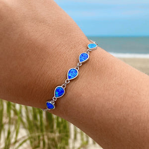Opal Droplet Bracelet worn on a woman's arm.