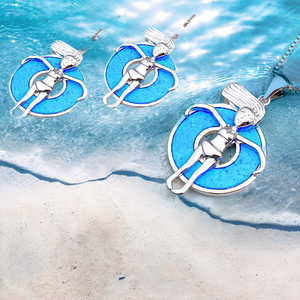 Opal Floatie Girl earrings and necklace showcased on the sandy beach shore.
