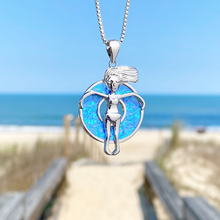 Load image into Gallery viewer, Opal Floatie Girl Necklace hanging close for a shot with a blurred beach background.