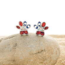 Load image into Gallery viewer, Opal Infinity American Flag Paw Studs are sitting on top of a rock.