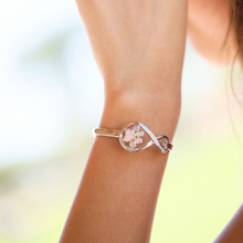 Load image into Gallery viewer, Opal Infinity Love Paw Cuff Bracelet in Pink being worn on a woman&#39;s arm.