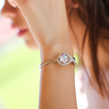 Load image into Gallery viewer, Opal Infinity Love Paw Cuff Bracelet in Pink being worn on a woman&#39;s arm.