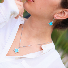 Load image into Gallery viewer, Opal Inlay Sea Star Necklace is displayed by being worn around a woman&#39;s neck.