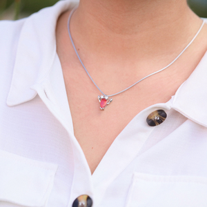 Opal Lobster Necklace is displayed by being worn around a woman's neck.