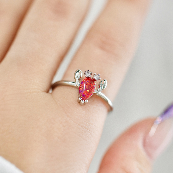 Opal Lobster Ring being shot up close while being worn on a finger.