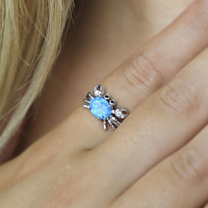 Opal Nautical Crab Ring displayed closely by being worn on a woman's finger.