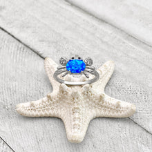 Load image into Gallery viewer, Opal Nautical Crab Ring is placed on top of a white dried artificial starfish.