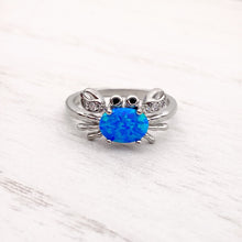 Load image into Gallery viewer, Opal Nautical Crab Ring displayed on a white wooden surface.