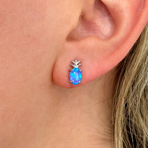 Opal Pineapple Stud Earrings worn on a woman's ear in a close-up shot.