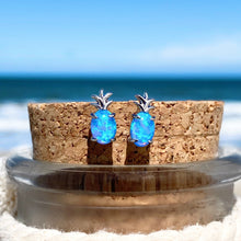 Load image into Gallery viewer, Opal Pineapple Stud Earrings placed on a cork on top of a bottle.