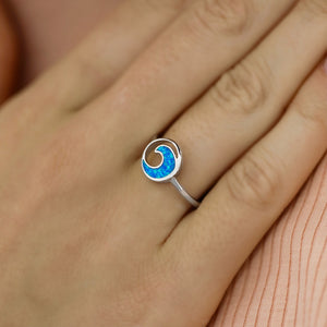 Opal Rip Curl Ring displayed by being worn on a woman's finger.