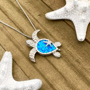 Opal Sea Turtle Starfish Necklace displayed on a wooden surface.