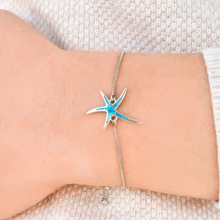 Load image into Gallery viewer, Opal Starfish Bracelet displayed by being worn around a woman&#39;s wrist.