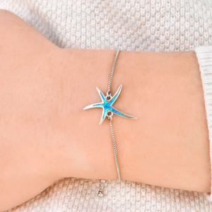Opal Starfish Bracelet displayed by being worn around a woman's wrist.