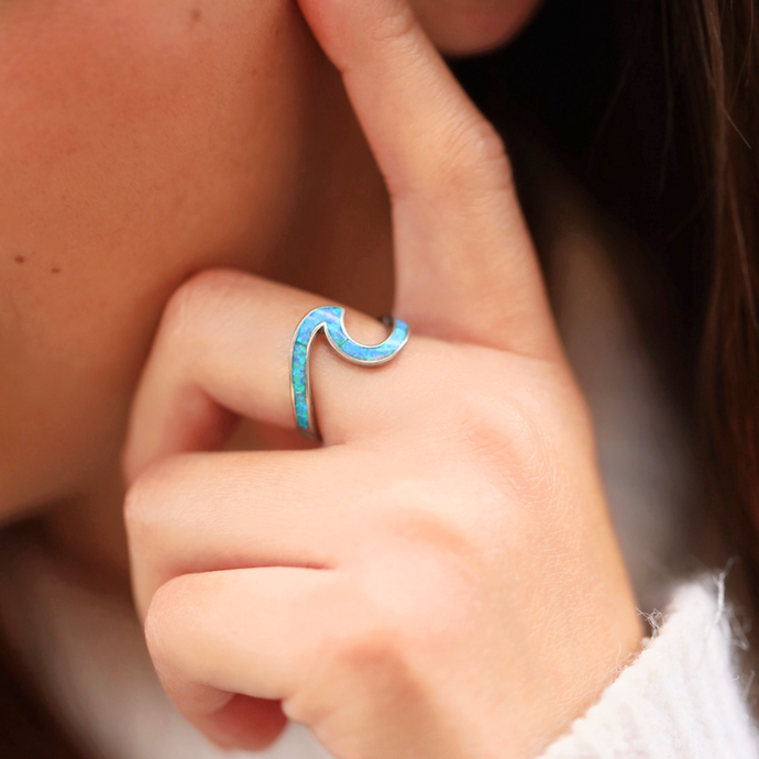 Opal Wave Ring displayed by being worn on a woman's finger.