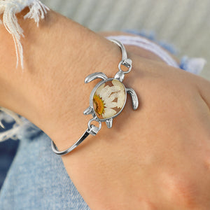 Pressed Daisy Sea Turtle Bracelet worn around a woman's wrist, ideal for beach-inspired jewelry.