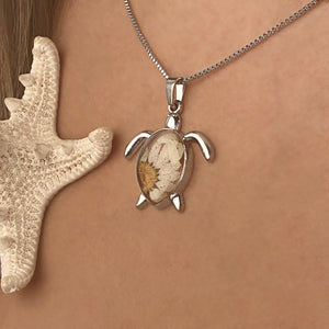 Pressed Daisy Sea Turtle Necklace worn around a woman's neck, perfect for ocean-inspired jewelry.