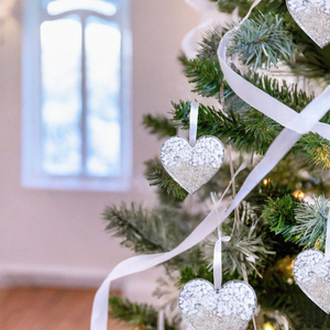 Sand Heart Ornaments are showcased by being placed on a Christmas tree.