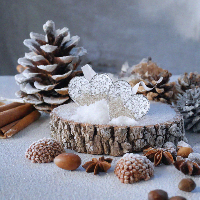 Sand Heart Ornaments are showcased on a winter-themed tabletop display.