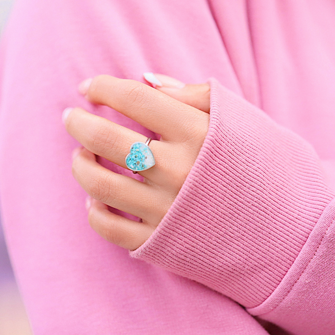 Sand Heart Ring displayed up close by being worn on a woman's hand.