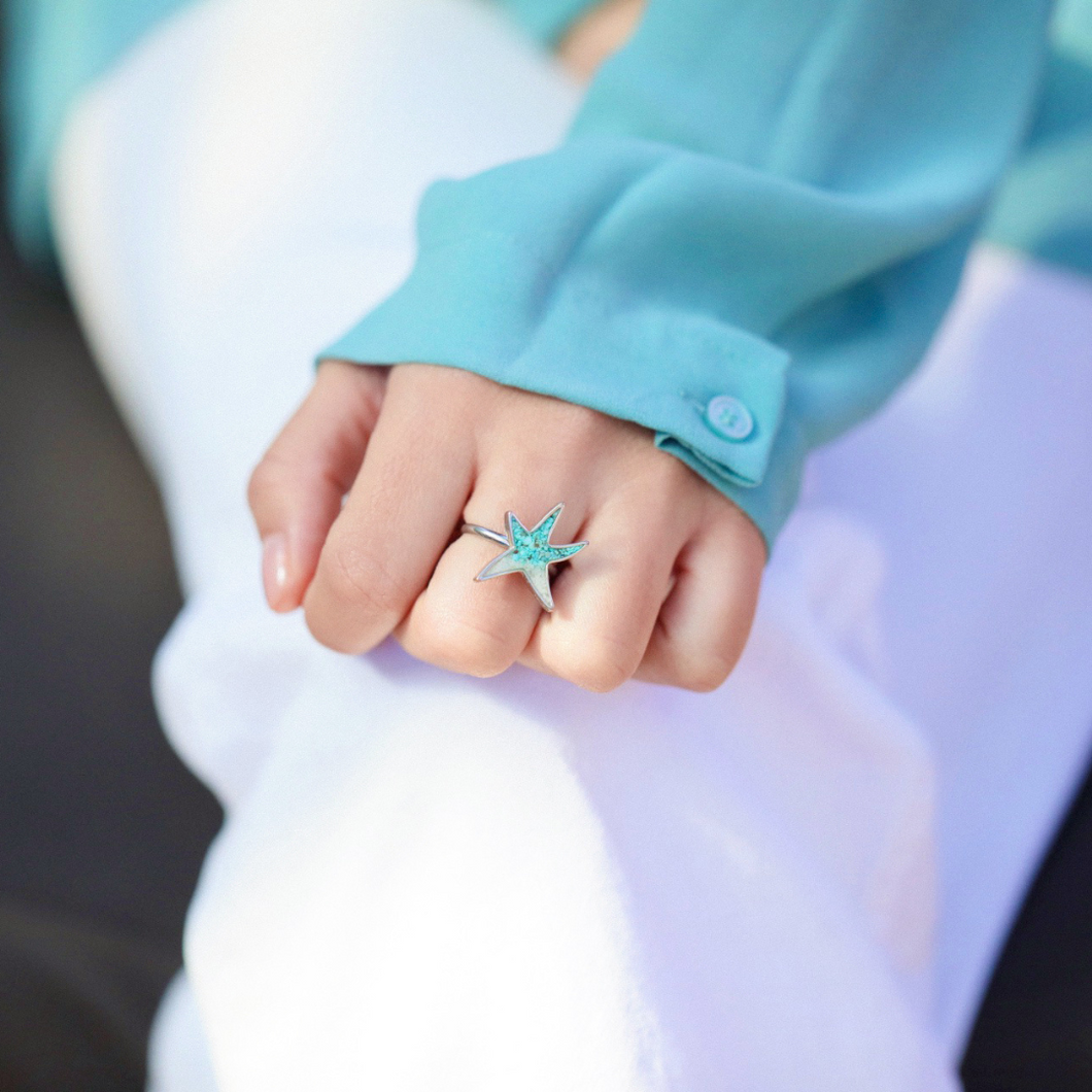 Sand Sea Star Ring displayed by being worn on a woman's finger.