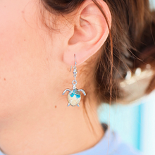 Load image into Gallery viewer, Sand Sea Turtle Earrings displayed up close by being worn.