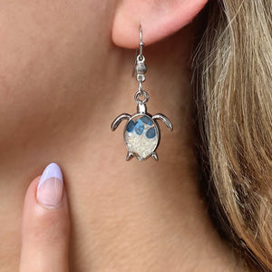 Sand Sea Turtle Earrings displayed by being worn on a woman's ear.