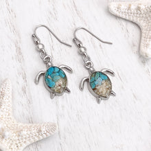 Load image into Gallery viewer, Sand Sea Turtle Earrings displayed on a white wooden surface.