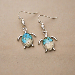 Sand Sea Turtle Earrings displayed on a wooden surface.