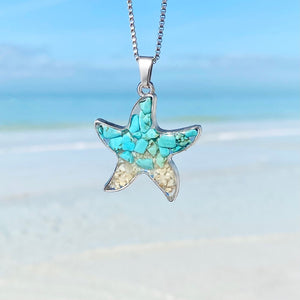 Sand Starfish Necklace hanging against a blurred beach background, perfect for beach-themed accessories.