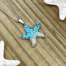 Load image into Gallery viewer, Sand Starfish Necklace in Teal Turquoise displayed on a wooden surface.