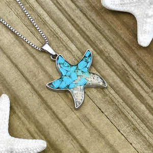 Sand Starfish Necklace in Teal Turquoise displayed on a wooden surface.