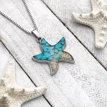 Load image into Gallery viewer, Sand Starfish Necklace in Teal Turquoise displayed on a white wooden surface.