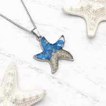 Load image into Gallery viewer, Sand Starfish Necklace in Blue Glass displayed on a white wooden surface.