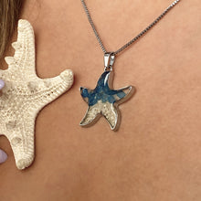Load image into Gallery viewer, Sand Starfish Necklace in Blue Glass displayed closely by being worn around a woman&#39;s neck.