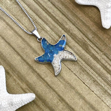 Load image into Gallery viewer, Sand Starfish Necklace in Blue Glass displayed on a wooden surface.