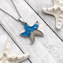 Load image into Gallery viewer, Sand Starfish Necklace in Blue Glass displayed on a white wooden surface