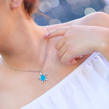 Load image into Gallery viewer, Sea Glass Sea Turtle Necklace in Skyblue displayed up close by being worn.