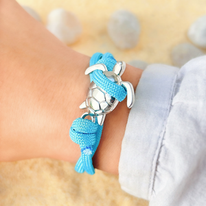 Sky Blue Rope Sea Turtle Bracelet displayed by being worn around a woman's wrist.