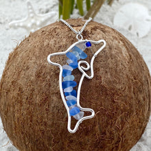 Load image into Gallery viewer, Stacked Sea Glass Dolphin Necklace displayed on top of a dried coconut.