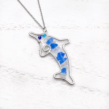 Load image into Gallery viewer, Stacked Sea Glass Dolphin Necklace displayed on a white wooden surface.