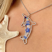 Load image into Gallery viewer, Stacked Sea Glass Dolphin Necklace displayed by being worn around a woman&#39;s neck.