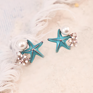 Starfish Pearl Studs displayed on a white furry surface.