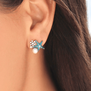 Starfish Pearl Studs displayed up close by being worn on a woman's ear.