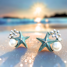 Load image into Gallery viewer, Starfish Pearl Studs is displayed on a glittering sandy shore.