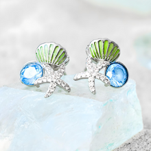 Load image into Gallery viewer, Starfish Shell Studs in Blue is displayed by being placed on top of a blue crystal.