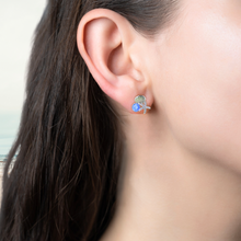 Load image into Gallery viewer, Starfish Shell Studs in Blue displayed by being worn on a woman&#39;s ear.