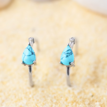Load image into Gallery viewer, Turquoise Droplet Hoop Earrings are displayed by being placed on the sand.