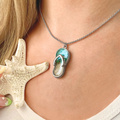 Turquoise Sandy Toes Necklace displayed by being worn around a woman's neck.